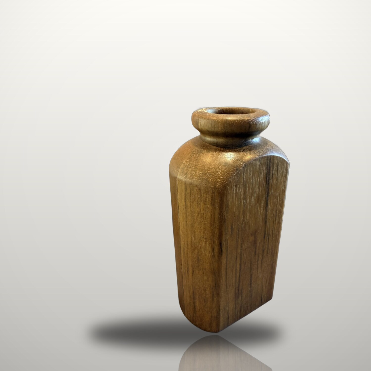 Greenheart bottle vase: dense wharf-pile timber, hand-turned with a round neck and a squared, faceted body